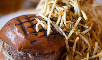  The Spotted Pig's chargrilled burger with roquefort cheese and rosemary shoestring fries.