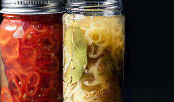 Jars of pickled Fresno chiles and banana peppers.