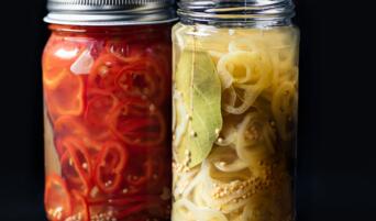 Jars of pickled Fresno chiles and pickled banana peppers