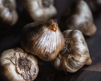 Heads of black garlic.