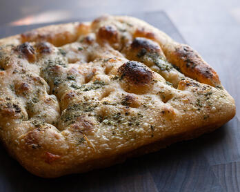 Unsliced Sun-dried Tomato, Rosemary & Basil Pesto Sourdough Focaccia. 